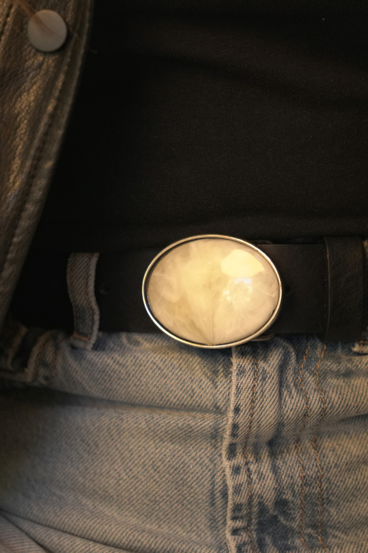 Détail de la boucle plaque ovale blanc nacré cerclée d'argent brossé de la ceinture Manar Atelier Nappa